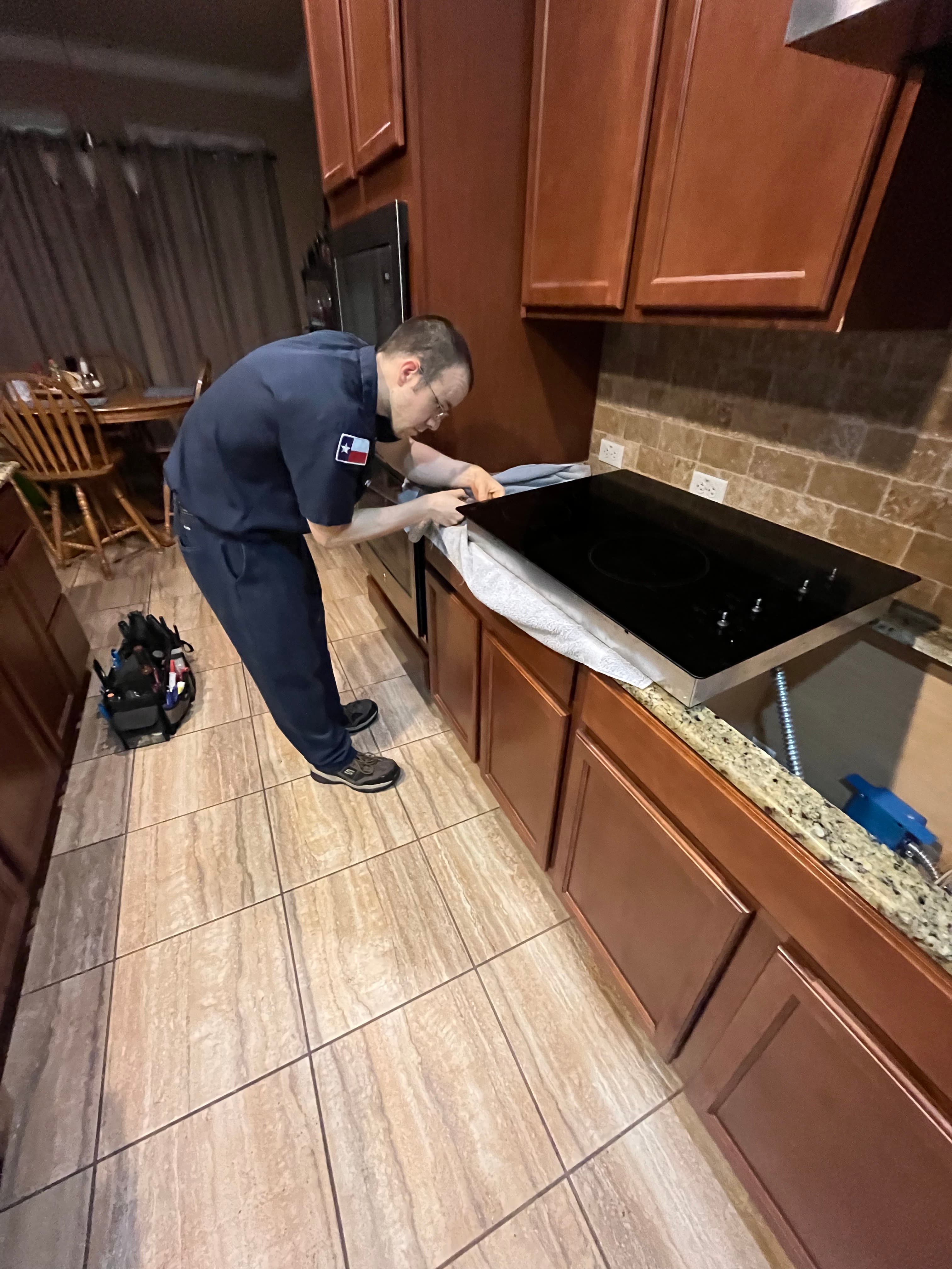 Tri City Service technician repairing a cooktop in a Bell County home